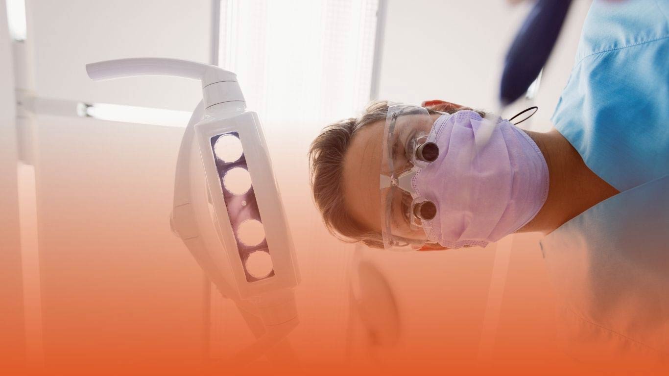 Dentist wearing a mask treating a patient: used as a blog banner for an antibiotic prophylaxis blog by Densura UK.