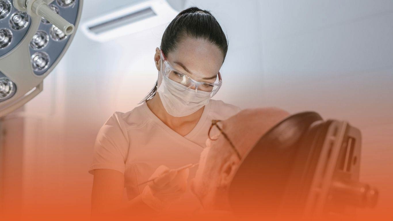 densura-blog-silver-diamine-fluoride Dentist treating a patient: used as a banner for a Densura blog on silver diamine fluoride.