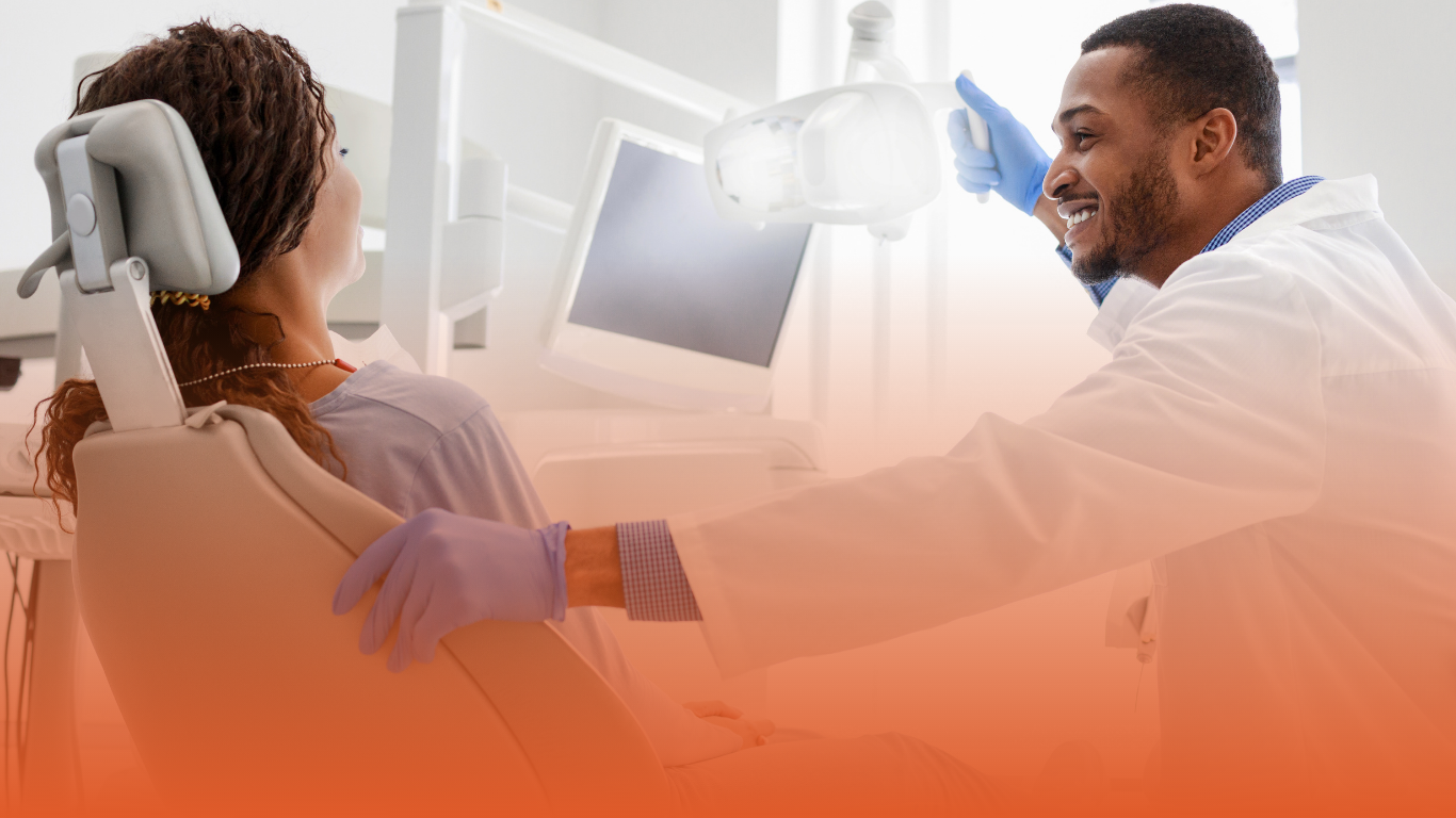 Banner image of a smiling dentist discussing treatment with a patient: used in a Densura blog that answers the question "can a dentist refuse to treat a patient​?"