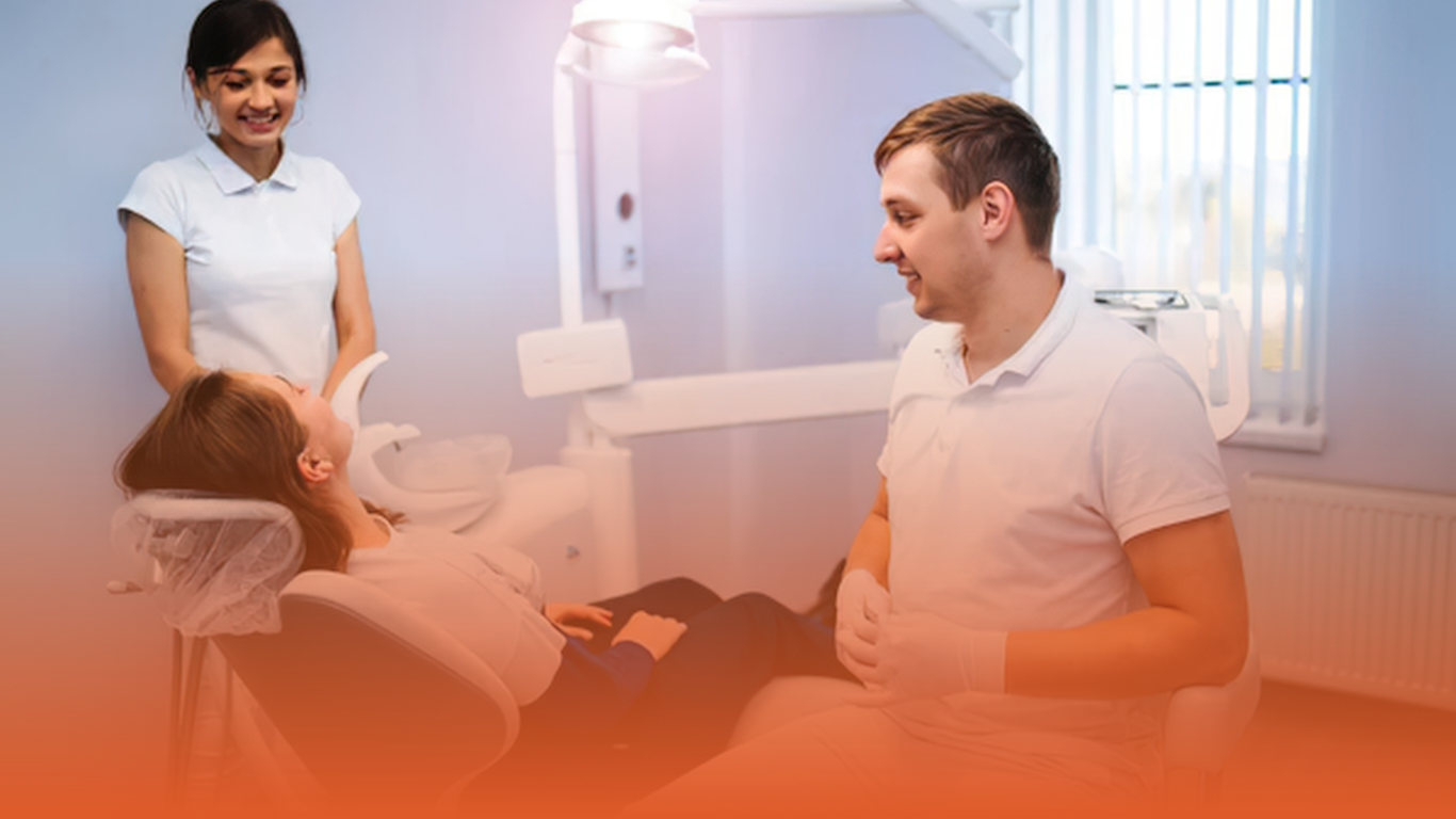 Helpful dentist consulting with a patient in accordance to GDC fitness to practise standards.